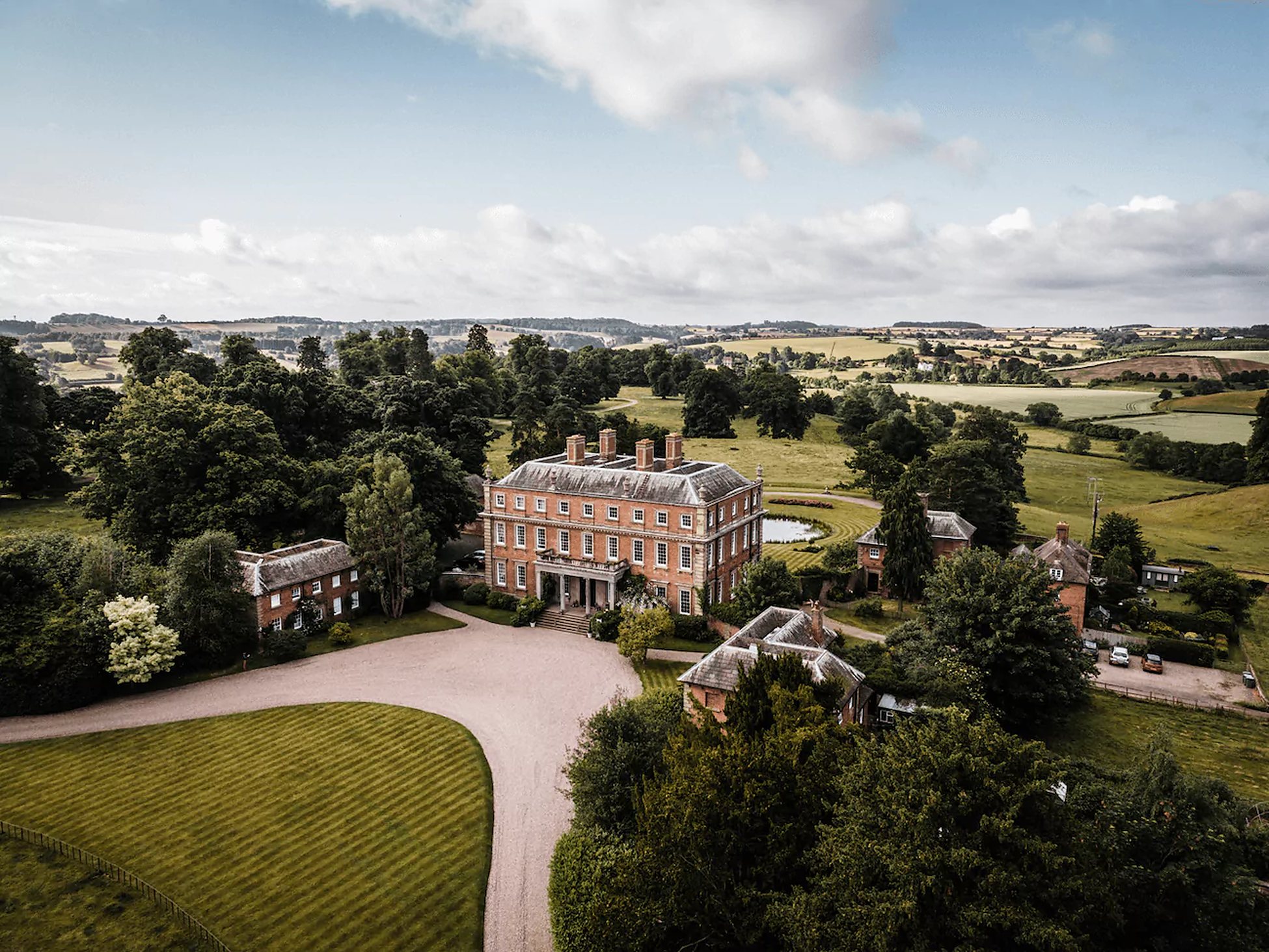 Aerial view of a country house set in parkland